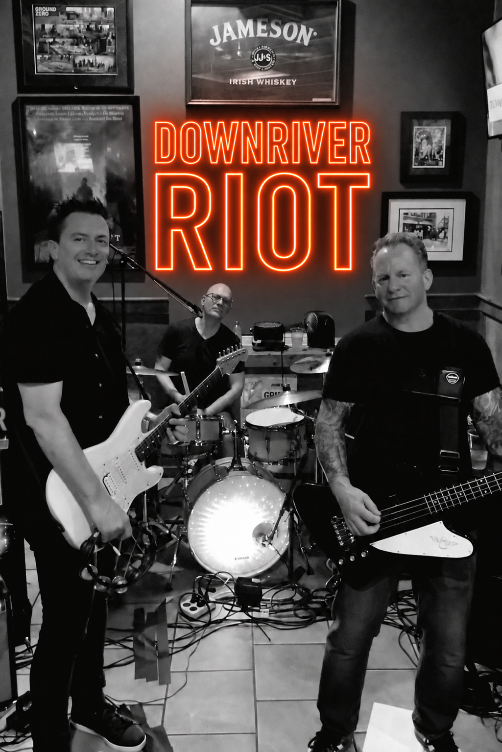 Downriver Riot performing live beneath the band's orange neon logo